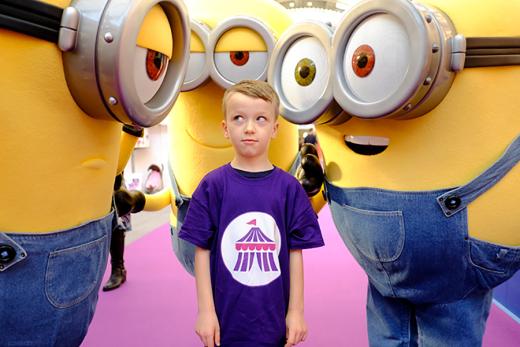 Child surrounded by minion characters