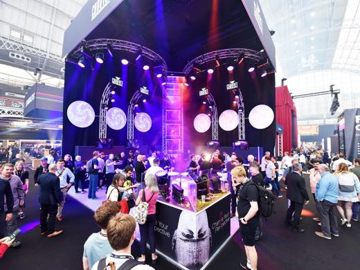 A large crowd of visitors looking at the Chauvet exhibiting stand at PLASA Show London 2022.