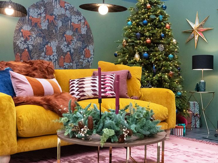 A beautiful yellow sofa, adorned with Christmas decorations 
