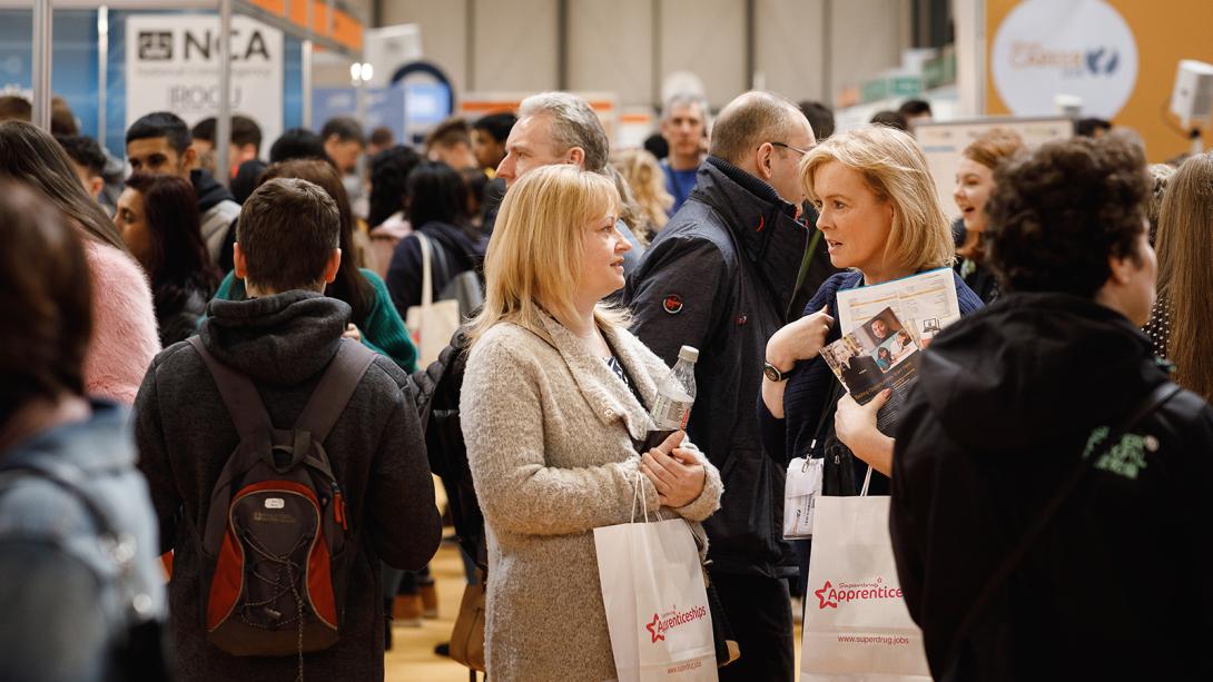 Visitors looking at exhibition stands